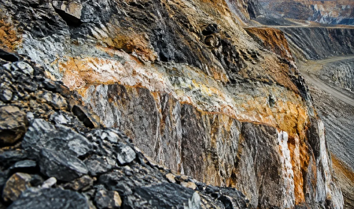 Couche minerale souterraine exposee dans excavation rocheuse profonde