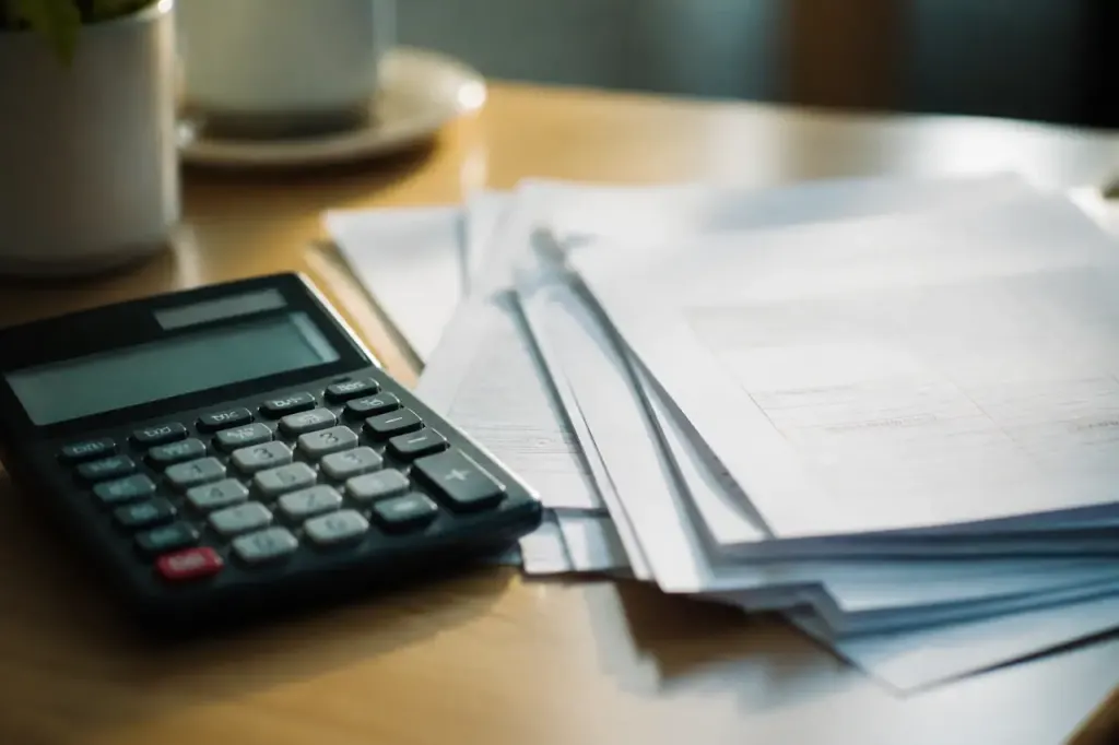 Calculatrice et factures medicales posees sur un bureau