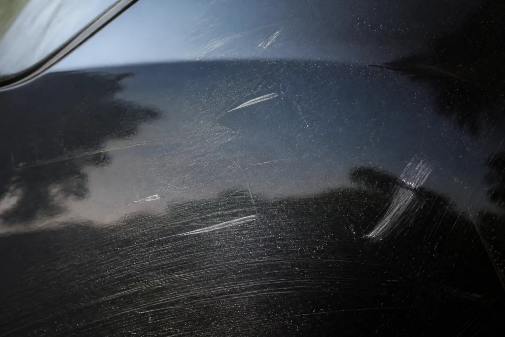 Surface noire avec rayures visibles et traces blanches